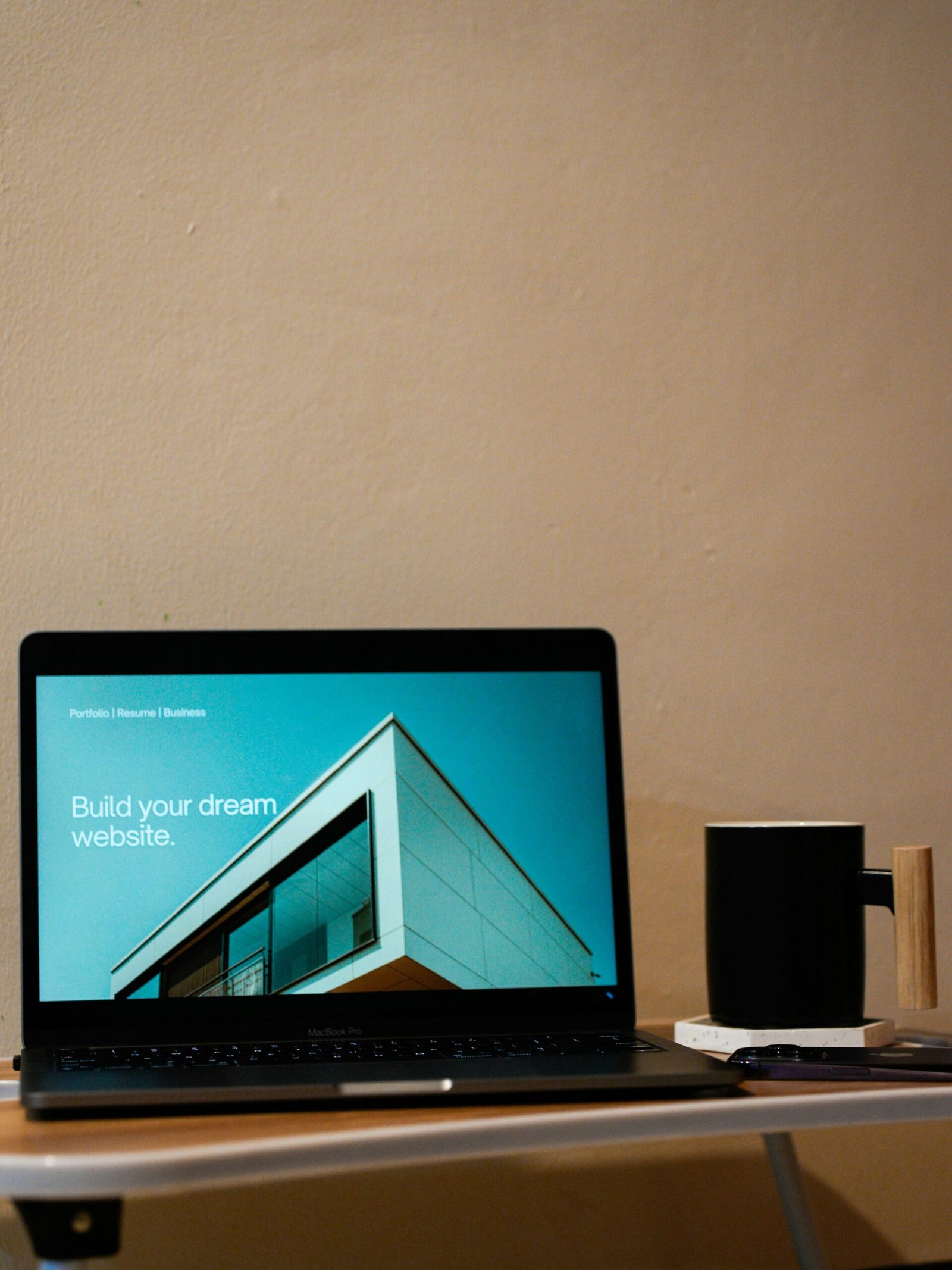 a laptop computer sitting on top of a wooden desk